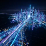 インフラストラクチャをコードで管理・自動構築するIaCを象徴する、光るコードの青写真から直接立ち上がるサイバー都市の高品質な写真